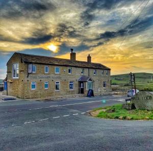 an old brick building on the side of a road at Self contained property in Cartworth