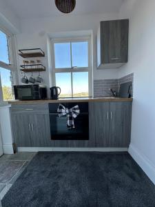 a kitchen with a counter with a bow on it at Self contained property in Cartworth