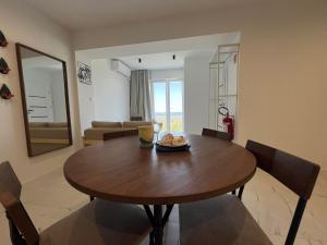 a dining room with a wooden table and chairs at Marta in Carini