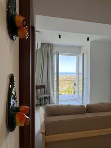 a living room with a couch and a large window at Marta in Carini