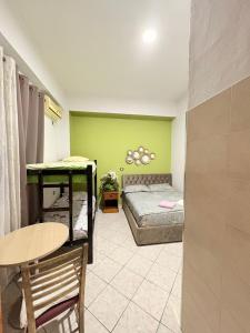 a room with a bed and a table and a table and a chair at Hotel-Bar-Riviera in Lezhë