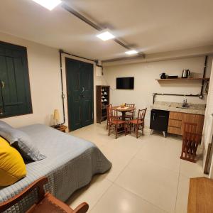 a bedroom with a bed and a table and chairs at Loft Macau in Diamantina