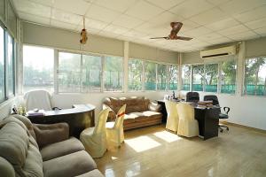 a living room with a couch and a table at Lake View Village Resort in Tajpur
