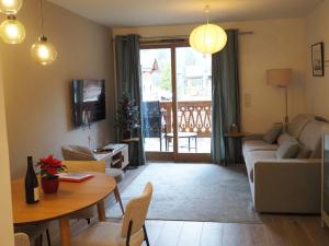 a living room with a couch and a table at Apartment Okami in Morzine
