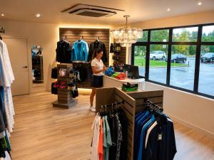 a woman standing at a counter in a clothing store at The Wiltshire Hotel, Golf and Leisure Resort in Swindon +24 photos