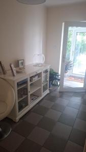 a room with a white counter with a window and a door at Hostel pod Modrzewiem in Świnoujście