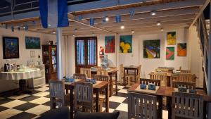 a restaurant with tables and chairs and paintings on the walls at HOTEL COSTANERA - Mejor Ubicacion en FORMOSA in Formosa