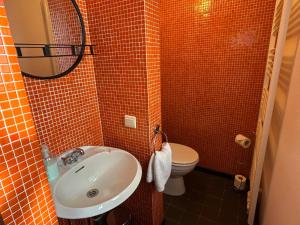 a small bathroom with a sink and a toilet at Studio Rue de Pommard in Francorchamps +20 photos