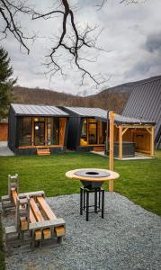 a modern house with a table and a bench at Wolfmoon Riverside in Lupşa
