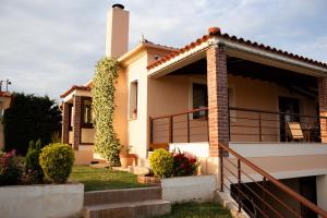 a house with a balcony and stairs at Hilltop House Dikella in Alexandroupoli
