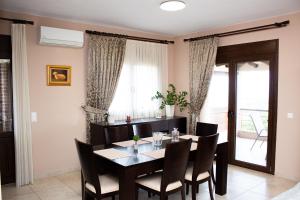 a dining room with a table and chairs at Hilltop House Dikella in Alexandroupoli