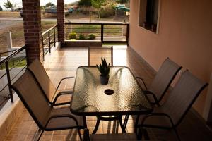 a table and chairs on a balcony with a potted plant at Hilltop House Dikella in Alexandroupoli +28 photos