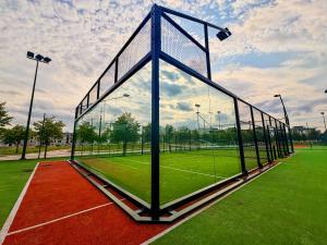 a tennis court with a net on a field at GrandHotel Tiffi in Iława