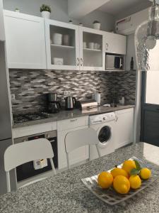 a kitchen with a plate of oranges on a counter at Cantinho de Mindelo in Mindelo