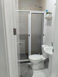 a bathroom with a shower and a toilet and a sink at Cantinho de Mindelo in Mindelo