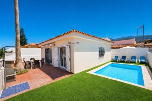 a villa with a swimming pool and a patio at CHALET 83 con PISCINA PRIVADA in Callao Salvaje