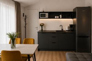 a kitchen with a table and a counter top at Pärnu Saunamaja saun, aed, mere lähedal ja tasuta parkimine in Pärnu +1 photo