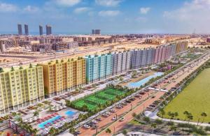 an aerial view of a city with many buildings at Amer group in El Alamein