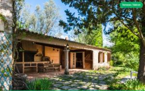 a stone house with a patio and a table at Le mas du goïo in Seillans