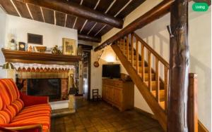 a living room with a couch and a fireplace at Le mas du goïo in Seillans