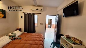 a hotel room with a bed and a flat screen tv at HOTEL COSTANERA - Mejor Ubicacion en FORMOSA in Formosa