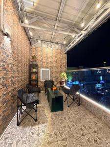 a room with chairs and a couch and a brick wall at OR Stay Semporna in Semporna