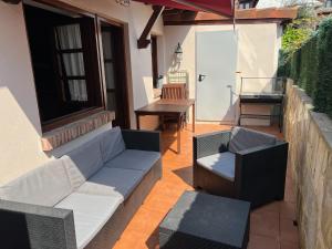 a patio with a couch and chairs and a table at Casa La Campa in Comillas