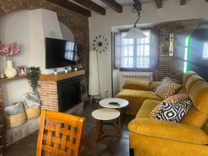 a living room with a couch and a fireplace at Casa La Campa in Comillas