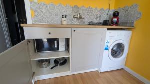 a kitchen with a washer and dryer in a room at Lovely Studio with a Balcony in Sinemorets