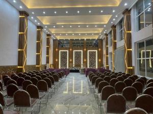 an empty hall with rows of chairs in a building at Xenious Opulent Hamirpur in Hamīrpur