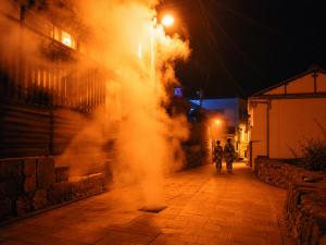 a fire hydrant on a street at night at 全5室の小さな温泉旅館 別府鉄輪温泉 萬力屋 in Beppu