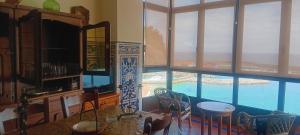a dining room with a table and a view of the ocean at Balcon del Alba VUT N1238 in Lastres