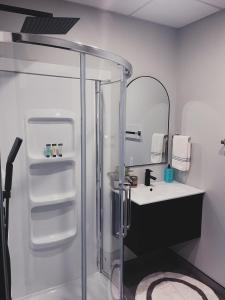 a bathroom with a shower and a sink at Falkenberg Business Centre and Suites in Botwood +37 photos