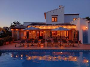 a house with a swimming pool in front of a house at Villa Villa Lantana by Interhome in Jávea