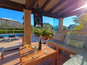 a patio with a couch and a table with wine glasses at Villa Villa Lantana by Interhome in Jávea