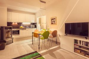 a kitchen with a table with chairs and a television at Sonnentraum in Zinnowitz