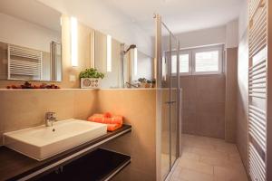 a bathroom with a sink and a shower at Sonnentraum in Zinnowitz +28 photos