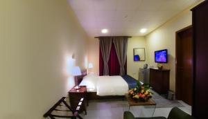 A television and/or entertainment centre at Palms Lily Hotel Suites