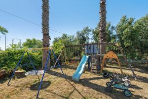 a playground with a slide and a swing set at B&B Pozzuoli - Suite Ermosa in Pozzuoli
