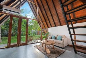 a living room with a couch and a table at Aalanga Escape in Kanugala