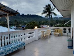 a balcony with chairs and a view of the mountains at The Cronin Residence in Oslob +51 photos