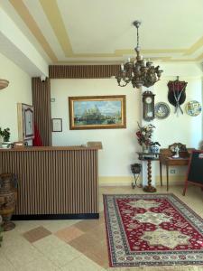 a living room with a table and a rug at Hotel "SAN SAENA " in Vlorë +117 photos