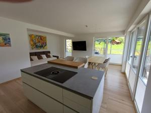 a kitchen and living room with a couch and a table at Ferienhaus Lurger in Strassen