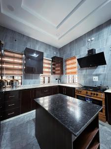 a large kitchen with a black counter top at The Movia Residences 1 in Enugu
