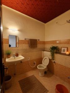 a bathroom with a toilet and a sink at The cliff boutique in Varkala +8 photos