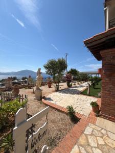 a walkway in front of a house with a statue at Hotel "SAN SAENA " in Vlorë