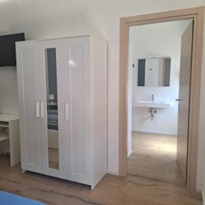 a white cabinet in a room with a sink at Mary's Sweet Home in Cagliari