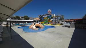 a water park with a slide in a playground at AQUA MARMARA LİFE Hotel in Marmaraereglisi