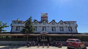 a building with motorcycles parked in front of it at AQUA MARMARA LİFE Hotel in Marmaraereglisi
