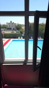 a view of a swimming pool through a window at AQUA MARMARA LİFE Hotel in Marmaraereglisi +1 photo